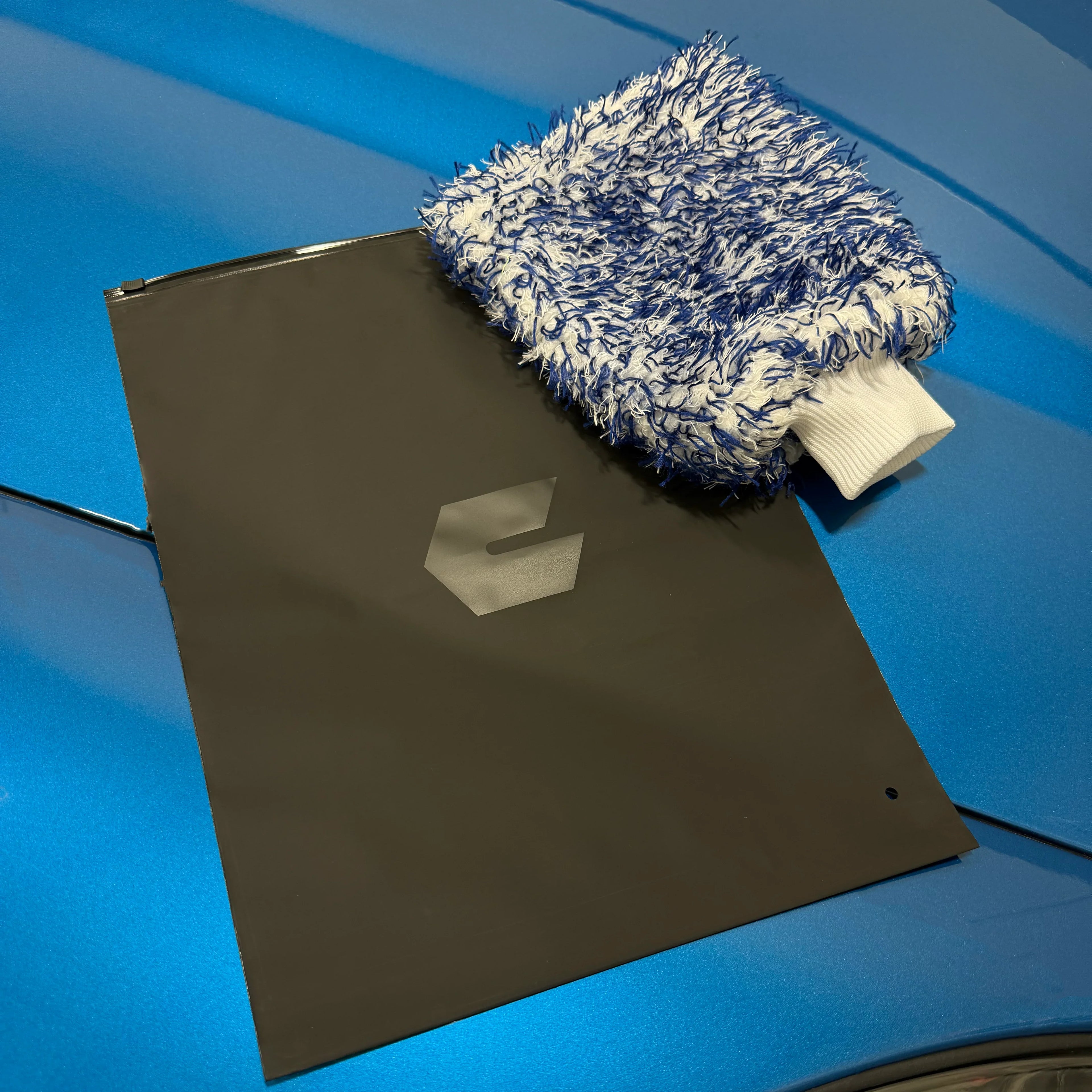 Ceratek microfiber wash mitt and branded bag on blue car hood for ceramic coating care